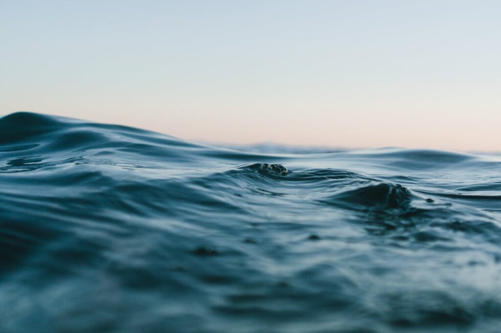 body of water under blue and white skies 1533720